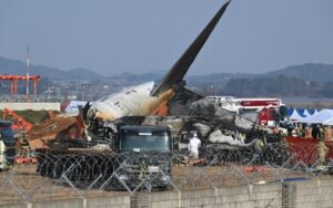 Bombeiros e equipes de resgate trabalham perto dos destroços do avião Boeing 737-800 da empresa sul-coreana Jeju Air que caiu no Aeroporto Internacional de Muan, cerca de 288 quilômetros a sudoeste de Seul, em 29 de dezembro de 2024