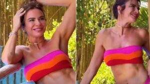 Luciana Gimenez posa de biquíni rosa e laranja ao sol e web reage