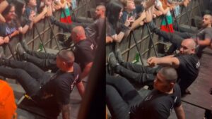 Seguranças fazem barreira para grade não cair em show
